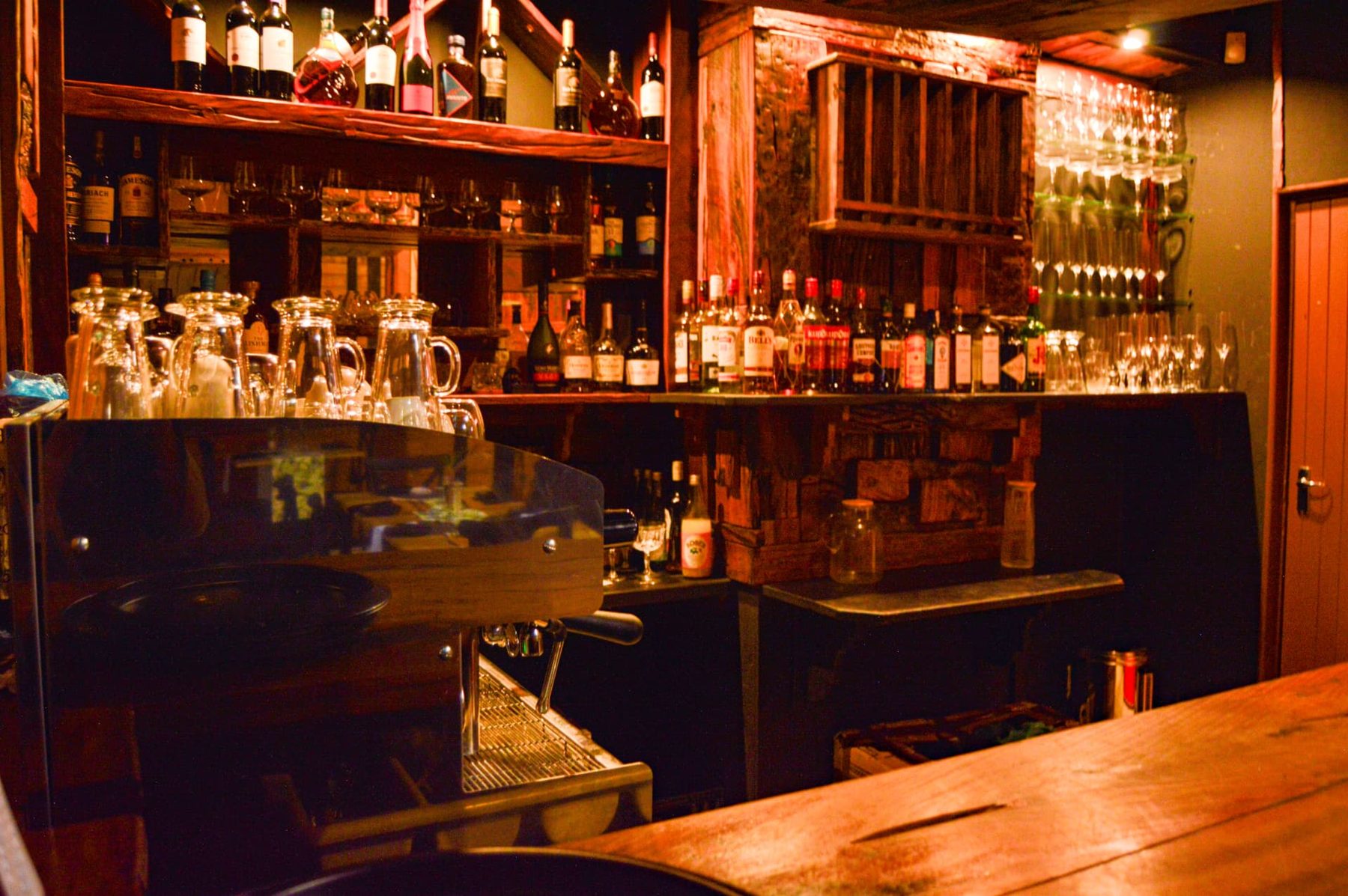 Timber bar with wine bottles and glasses