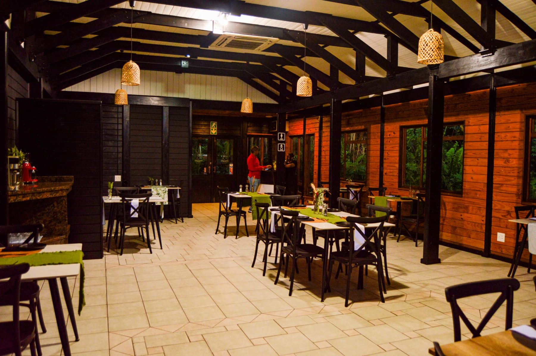 In The Reeds Restaurant interior with timber beams and forest-facing windows