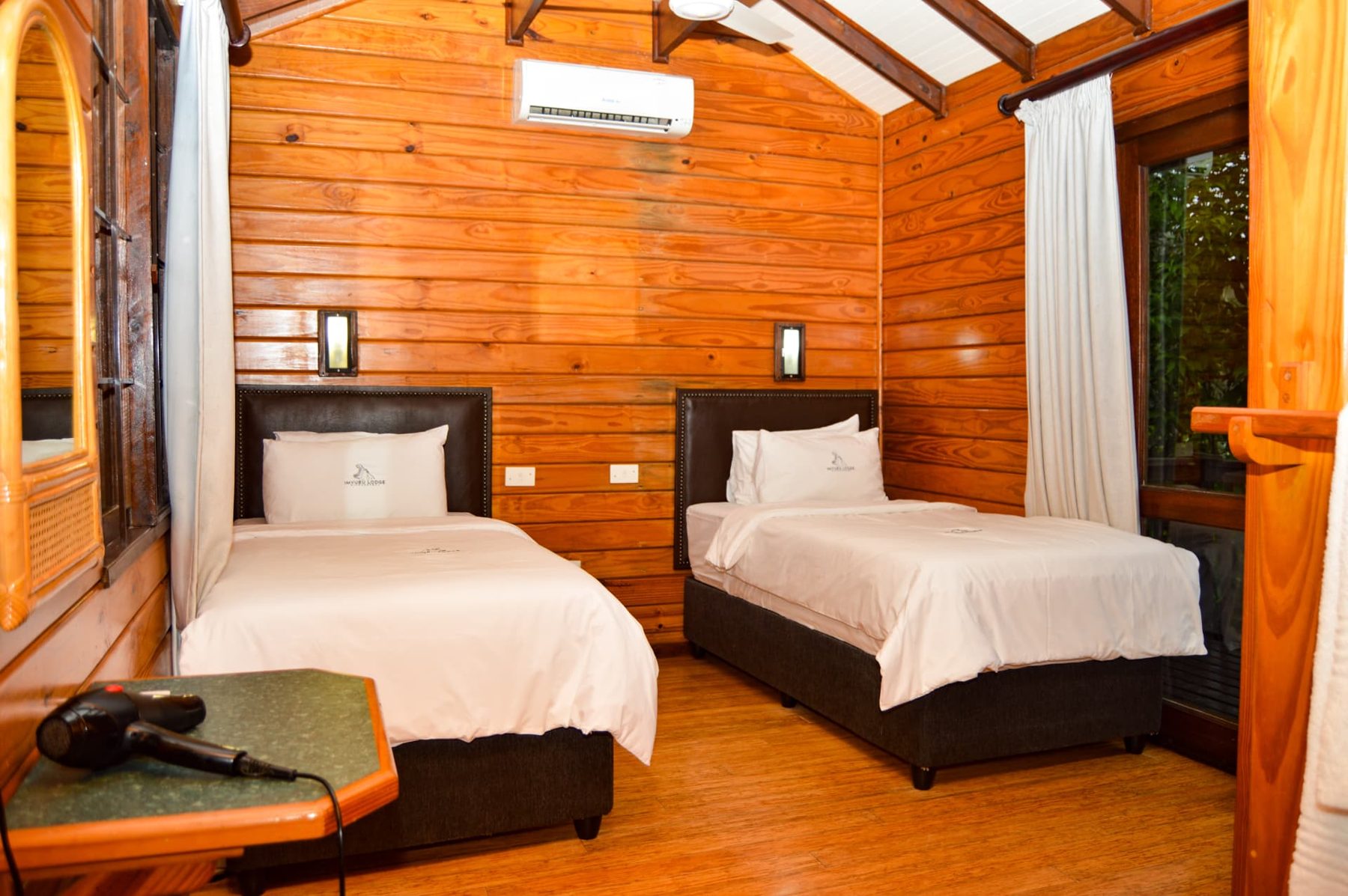 Deluxe Chalet twin bedroom with timber walls and deck access