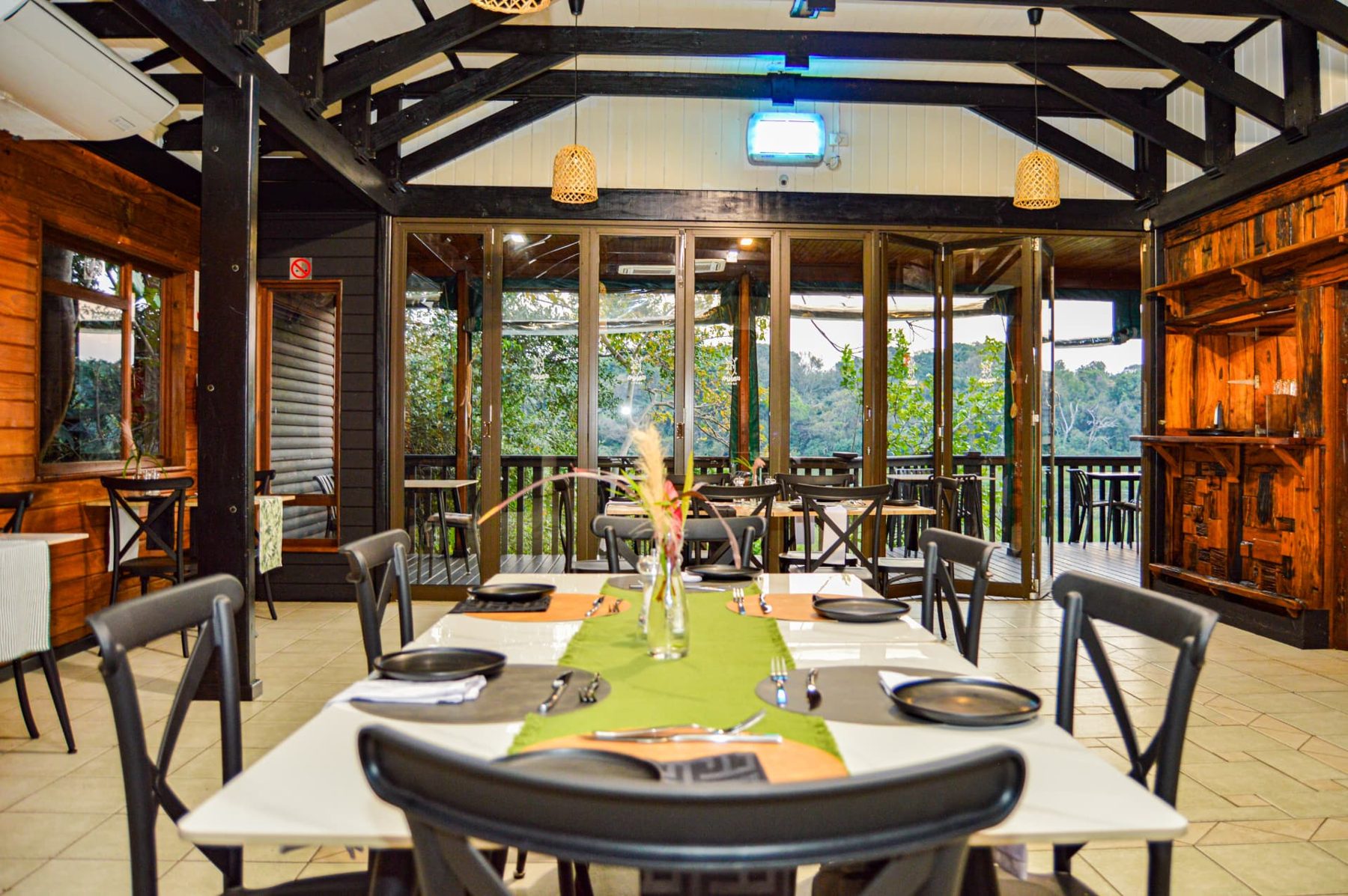 Set tables and glass doors opening to the restaurant deck