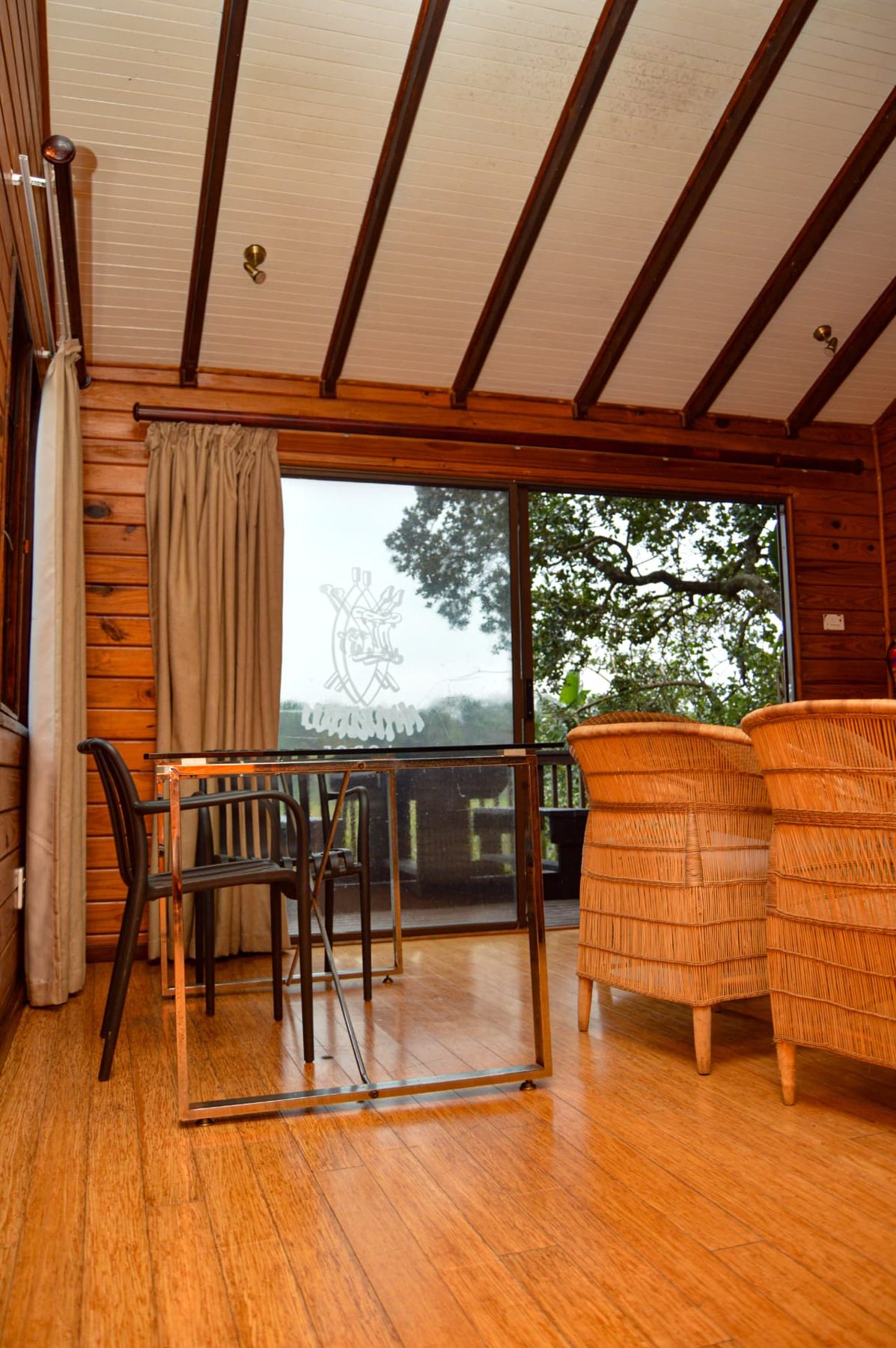 Deluxe Chalet sitting area with wicker chairs and vaulted ceiling