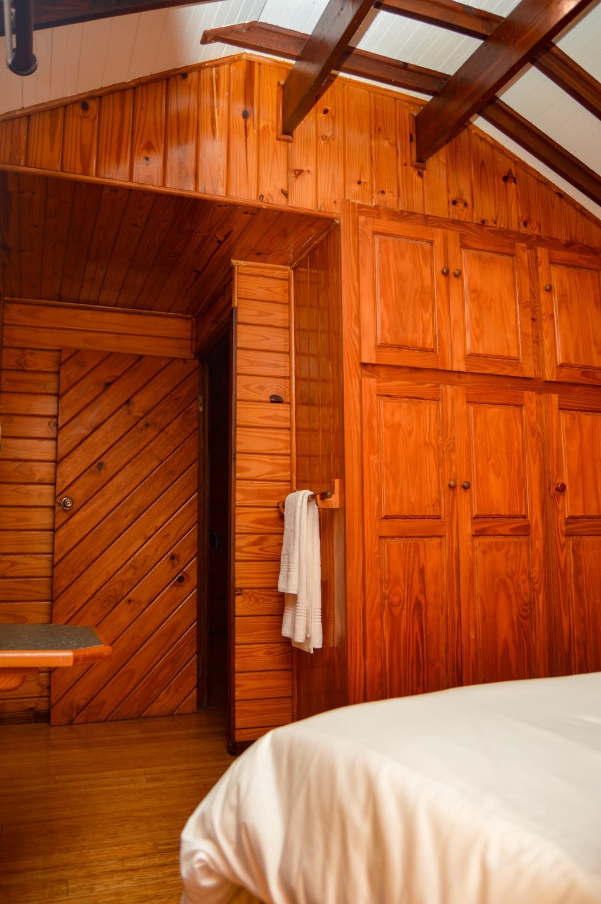 Chalet bedroom with timber walls